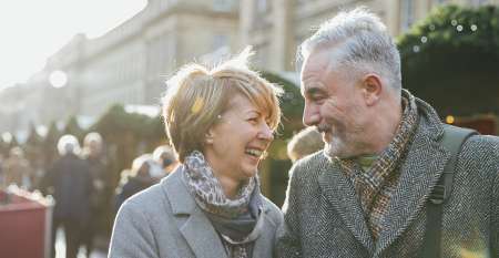 Close older couple laughing together