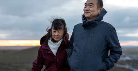 Couple on balcony at sunset