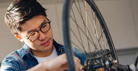 Man fixing bicycle wheel