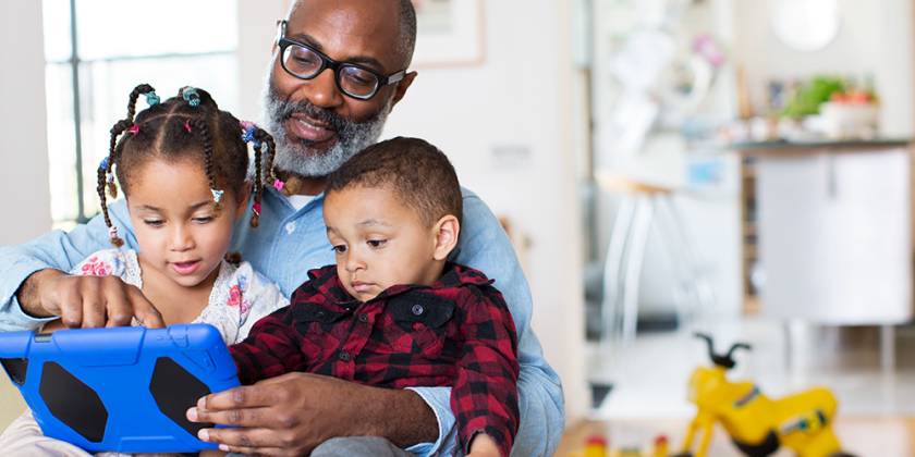 Man holding two young children