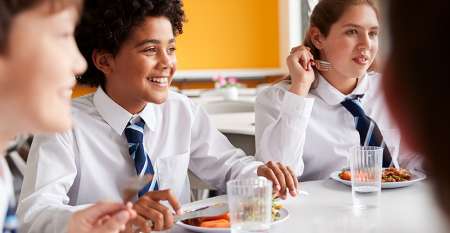 School children eating at dining table