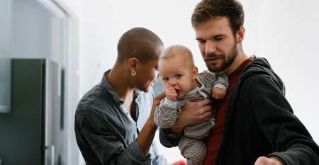 Two young men with baby