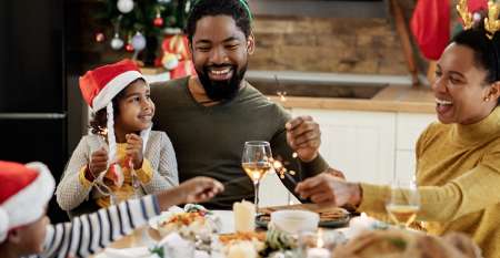 Young family enjoying Christmas lunch