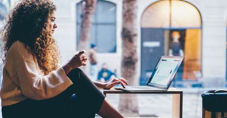 young-woman-using-laptop-in-cafe