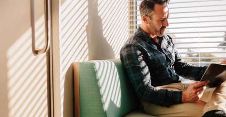Man looking serious reading notes in reception room