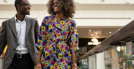 Smartly dressed smiling couple in shopping mall