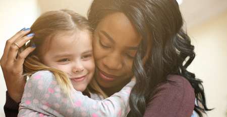 Woman and little girl hugging