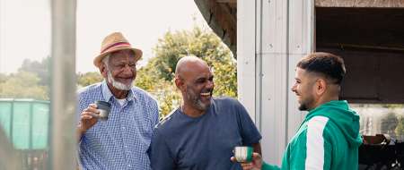 Three men laughing together