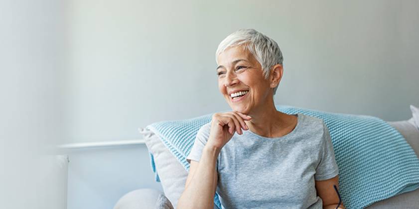 Happy senior woman relaxing on sofa